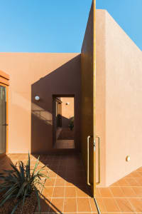 Modern architectural space with concrete walls and floor, featuring clean lines and geometric shapes.