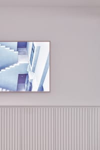 A modern interior with concrete steps and walls, featuring a minimalist design.