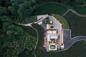 Aerial view of a modern residential building with a concrete and glass exterior.