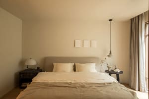 A minimalist bedroom with neutral tones and simple decor.