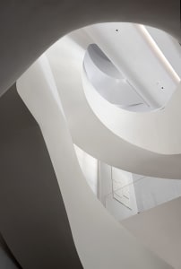 A minimalist white concrete staircase with a sleek, modern design.