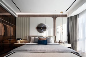 A modern bedroom featuring fabric bedding, metal accents, and wooden elements.