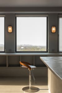 A modern kitchen with a concrete countertop and minimalist design.