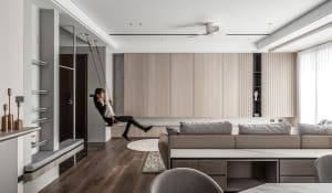 A modern living room featuring a wooden swing and marble furniture.