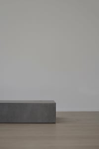 A minimalist furniture piece crafted from concrete.