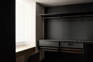 Modern minimalist closet with metal finishes and integrated storage solutions.