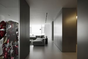 Modern living room with exposed concrete walls and minimalist furniture.