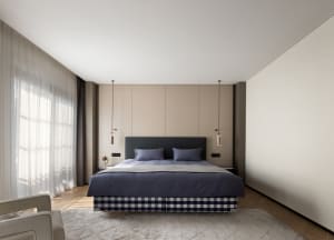 A modern bedroom with neutral color palette and textile accents.