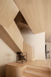 A modern, minimalist interior design featuring wooden materials and clean lines.
