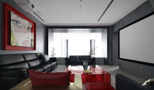 Modern living room with a glass coffee table, black leather couches, and a concrete floor.