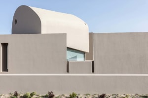 A minimalist architectural wall constructed from concrete.