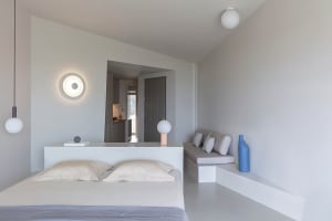 Modern minimalist bedroom with neutral tones, designed for comfort and simplicity.