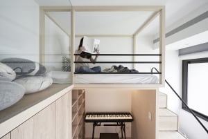 A minimalist study bedroom featuring wooden furniture and a lofted bed.