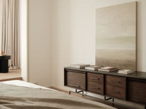 Modern minimalist bedroom featuring a wooden cabinet with books and a framed abstract painting.