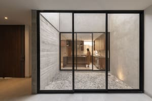 Industrial residential kitchen with concrete walls and floor.