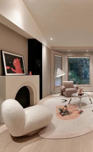 A modern, neutral-toned living room with a comfortable seating area and a fireplace.