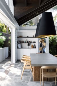 Modern dining room featuring a concrete table and minimalist design elements.