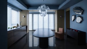 Modern dining room featuring metallic furniture and concrete flooring.