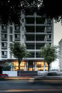 Modern residential building with concrete, glass, and metal materials.