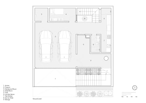 Floor plan of a modern residential building with two cars parked in the carport, a maid room, and storage units.