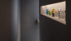 A minimalist display features various colorful toy figures.