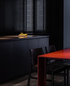 Modern kitchen with black countertops and metal finishes.