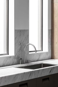 Modern kitchen featuring marble countertops and backsplash with a sleek, minimalistic design.