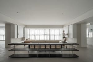 A modern living room with neutral-colored furniture and a minimalist design.