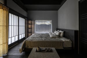 A contemporary minimalist bedroom featuring wood elements.