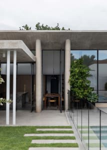 A modern exterior design featuring concrete and glass materials.