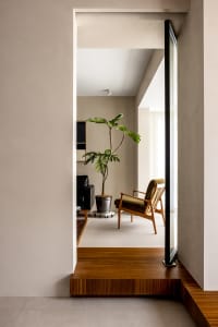 A minimalist living room featuring wooden furniture.