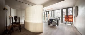 Contemporary minimalist living room with wood flooring, glass windows, and a paper wall divider