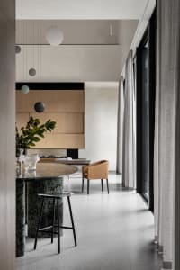 A modern living room featuring marble and glass elements.
