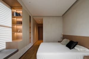 A modern minimalist bedroom with wood and concrete elements