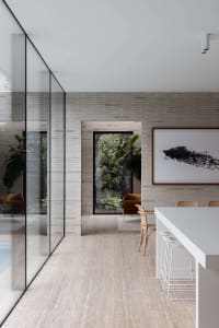 Modern interior with concrete walls, glass walls, and a minimalist design