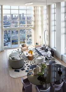 Modern living room with cityscape view, featuring contemporary furniture and decorative elements.