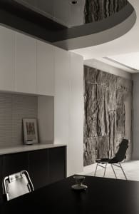A modern office space featuring concrete walls and a minimalist design.