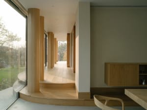Modern interior with wooden columns and light-colored walls.