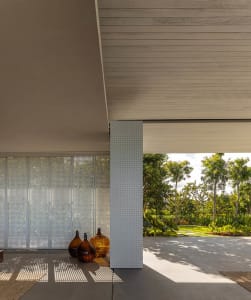 Modern, minimalist house exterior featuring concrete and perforated metal
