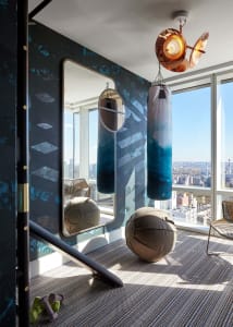 A modern home gym featuring exercise equipment and a large window with a city view.