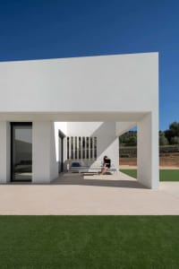 A modern architectural exterior featuring concrete and glass elements.
