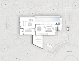 Floor plan of a modern house, depicted on paper with white lines on a textured gray background.