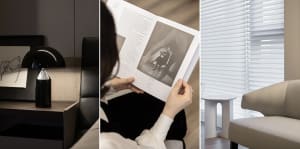 Person reading a book with a black and white photograph inside a modern interior with black and white window shades.