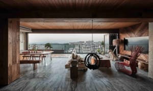 Modern living room with wooden floor, minimalist furniture, and outdoor view