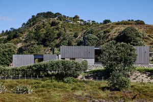 A modern residential building with metallic and stone exterior materials.