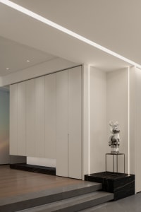 A minimalist interior design featuring concrete and metal elements.