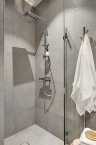 Modern bathroom featuring a concrete tile shower with a minimalist design.