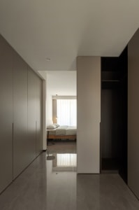A modern minimalist bedroom with white walls and a minimalist bed.