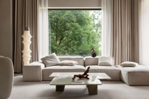 Modern residential living room with concrete floor, marble coffee table, and white floor.