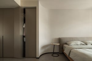 Minimalist bedroom with a neutral color palette and simple, uncluttered decor.